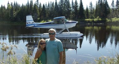 Couple in front of the sea plane on the water